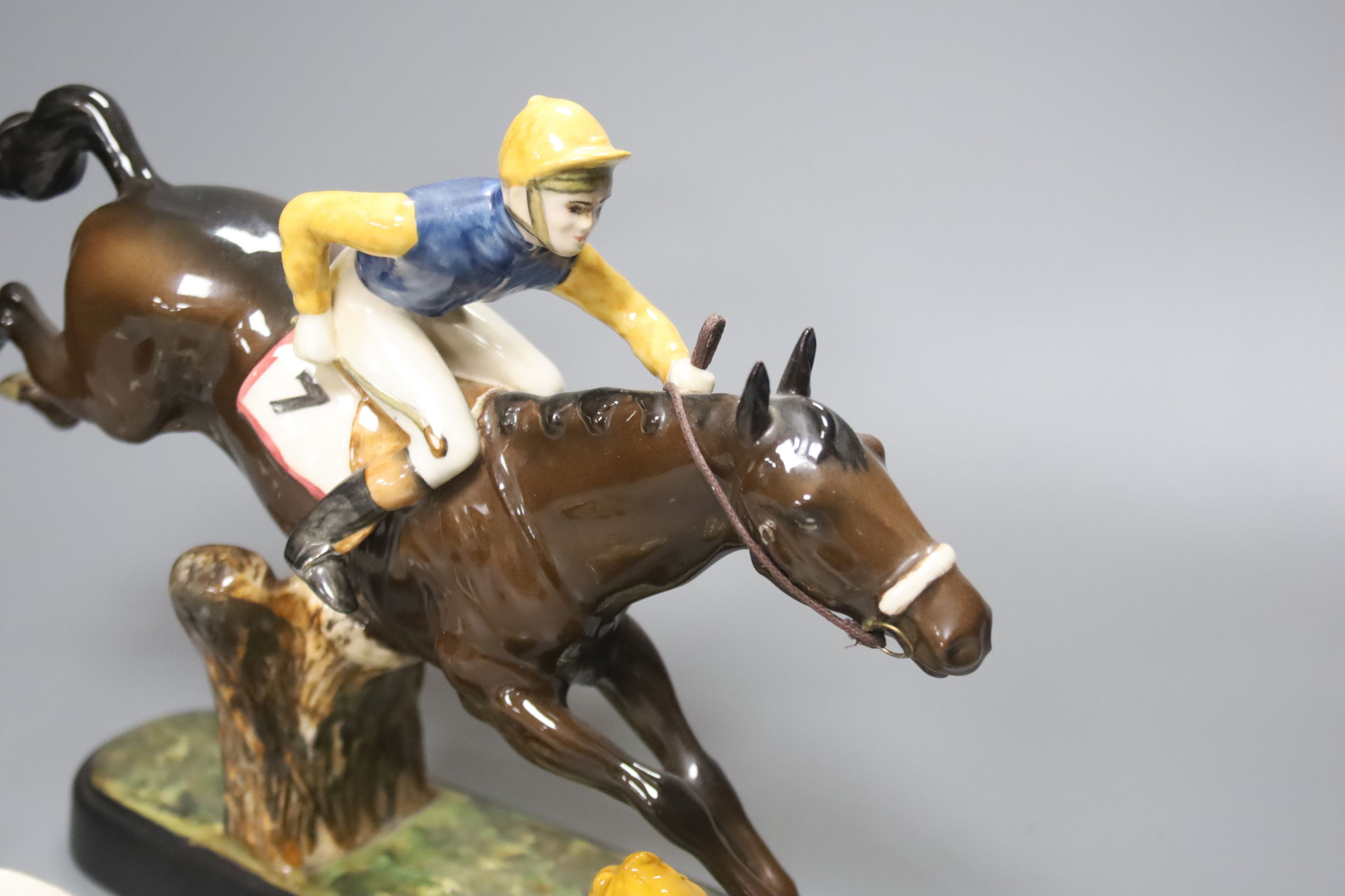 A Beswick racehorse and jockey, height 22cm, a Beswick child playing piano, a Royal Crown Derby bear footballer and a Continental earth